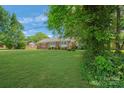 Lovely single-story home surrounded by a well-manicured lawn and mature trees at 8206 Idlewild Rd # 22, Indian Trail, NC 28079
