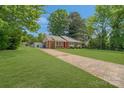 Quaint single-story home with a long driveway and a lush green lawn at 8206 Idlewild Rd # 22, Indian Trail, NC 28079