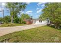 Expansive view of the home showing a long driveway and mixed brick and siding on the exterior at 830 Cabaniss Dr, Shelby, NC 28150
