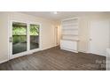 Bright living room with built-in shelving, hardwood floors, and sliding glass doors to the deck at 830 Cabaniss Dr, Shelby, NC 28150