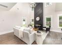 Living room boasts a soaring ceiling, fireplace with black accent wall, and ample natural light at 9527 Walkers Ferry Rd, Charlotte, NC 28214