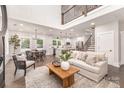 Spacious living area open to kitchen featuring modern decor, wood floors, and ample lighting at 9527 Walkers Ferry Rd, Charlotte, NC 28214