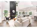 Open-concept living area with fireplace, high ceilings, hardwood floors, and access to the dining area at 9527 Walkers Ferry Rd, Charlotte, NC 28214