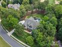 Expansive aerial view of a private home featuring mature trees and a backyard pool and golf course view at 1007 Wessington Manor Ln, Fort Mill, SC 29715