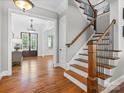 Open and bright foyer with hardwood floors and a staircase with wood and iron railings at 1007 Wessington Manor Ln, Fort Mill, SC 29715