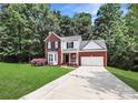 Charming two-story brick home featuring a bay window, manicured lawn, and an attached two-car garage at 101 Creekside Dr, Fort Mill, SC 29715