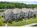 Gorgeous aerial view of condo building with lush greenery and multiple balconies at 104 Pier 33 Dr # 311, Mooresville, NC 28117