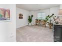 Bright living room with neutral carpet and natural light from window at 104 Pier 33 Dr # 311, Mooresville, NC 28117