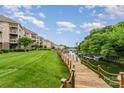 Beautiful waterfront view featuring a private boat dock, lush grass and mature trees at 104 Pier 33 Dr # 311, Mooresville, NC 28117
