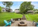 Large backyard with stone steps and firepit seating area at 10452 Quiet Bay Ct, Charlotte, NC 28278