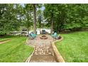 View of the beautiful backyard firepit area near the lake at 10452 Quiet Bay Ct, Charlotte, NC 28278