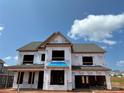 New construction home showing the exterior of a two-story residence with Tyvek wrap and a roof at 1102 Sugar Creek Rd, Indian Land, SC 29707
