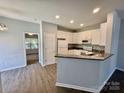 Updated kitchen with white cabinets, granite countertops, stainless appliances, and a breakfast bar at 1176 Constitution Park Blvd, Rock Hill, SC 29732