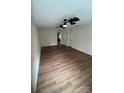Open living room featuring ceiling fan, neutral walls, and wood-look flooring at 135 Locomotive Ln # 106, Mooresville, NC 28115