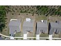 An aerial perspective highlights the home, patio, and well-maintained backyard within a residential community at 1360 Dali Blvd, Mount Holly, NC 28120