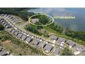 Aerial view of community homes, a future marina, and community lake access providing scenic waterfront living at 1360 Dali Blvd, Mount Holly, NC 28120
