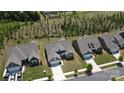 An aerial view of the home showcasing its location in a neighborhood with mature trees and manicured lawns at 1360 Dali Blvd, Mount Holly, NC 28120