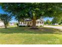 Traditional home with pristine lawn, mature trees, and a welcoming front porch at 1560 Springlake Rd, York, SC 29745