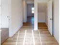 Inviting entryway featuring wood-look floors, white walls, and an open doorway to another room at 1817 Augustine St, Monroe, NC 28112