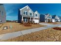 Beautiful gray two-story home with brick accents, a well-maintained lawn, and a two-car garage at 1817 Augustine St, Monroe, NC 28112