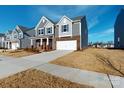 Attractive two-story home featuring gray siding, brick accents, and a spacious driveway on a sunny day at 1817 Augustine St, Monroe, NC 28112