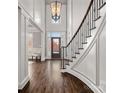 Elegant foyer with a stunning staircase, high ceilings, and a view of the front door, creating a grand entrance at 18823 Peninsula Cove Ln, Cornelius, NC 28031