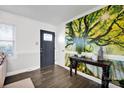Inviting entryway with dark wood floors, a tree mural, and a decorative console table at 1924 Lakeview Dr, Rock Hill, SC 29732