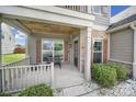 Inviting covered front porch with stone accents, a bench, and a well-maintained garden at 2015 Knocktree Dr, Indian Trail, NC 28079