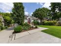 Inviting one-story home with lush landscaping, a well-maintained lawn, and a driveway leading to a garage at 2124 Chatham Ave, Charlotte, NC 28205