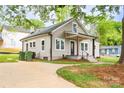 This home offers a long driveway with an updated exterior paint at 225 N Lee St, Mount Holly, NC 28120