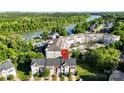 Stunning aerial view of community near the water with a large in-ground pool at 245 Rock Ridge Ln, Mount Holly, NC 28120