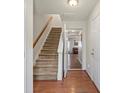 Inviting entryway featuring hardwood floors, staircase, and access to living spaces at 245 Rock Ridge Ln, Mount Holly, NC 28120