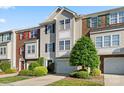 Charming townhome with well-manicured lawn and attached garage on a sunny day at 245 Rock Ridge Ln, Mount Holly, NC 28120
