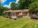 Spacious backyard featuring a wooden deck with built-in benches, perfect for outdoor entertaining at 2808 Findley Rd, Statesville, NC 28625