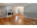 Bright living room featuring hardwood floors, a decorative fireplace and a large window at 2808 Findley Rd, Statesville, NC 28625