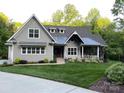 Well-maintained home features a lush green lawn and a cozy front porch, perfect for enjoying the outdoors at 3201 Johnny Cake Ln, Charlotte, NC 28226