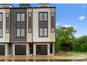Modern townhome featuring a stylish facade with large windows, a garage, and a well-maintained exterior at 3220 Riley Ave, Charlotte, NC 28269