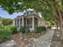 Charming exterior with a screened-in porch, lush landscaping, and a well-maintained walkway at 332 Delburg St, Davidson, NC 28036