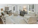 Bright living room with neutral color palette, plantation shutters, and hardwood floors at 3620 Champaign St, Charlotte, NC 28210