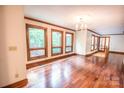 Living room featuring hardwood floors, natural light, chandelier, and neutral walls at 3700 Nw Gainesway Nw Ct, Concord, NC 28027