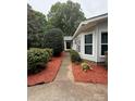 Inviting walkway with red mulch leads to the front door of this well-maintained single story home at 400 Archibald Rd, Concord, NC 28025