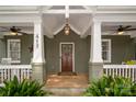 Inviting front porch features classic columns, ceiling fans, and a warm, welcoming ambiance at 417 N Dotger Ave, Charlotte, NC 28204