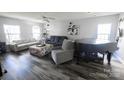 Bright living room featuring wood floors, modern decor, and plenty of seating at 417 Trillium Sw Ct, Conover, NC 28613