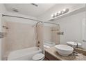 Bathroom features tile flooring, large mirror, tub, and tiled shower at 513 N Graham St # 1B, Charlotte, NC 28202