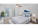 Cozy bedroom features natural light from two windows and soft carpet at 513 N Graham St # 1B, Charlotte, NC 28202