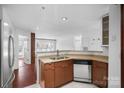 Well-lit kitchen featuring tiled floors, modern sink, and updated countertops at 513 N Graham St # 1B, Charlotte, NC 28202