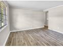 Bright, open living room with neutral walls, new flooring, and large windows letting in natural light at 5221 Wales St, Charlotte, NC 28269