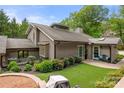 Charming single-story home with a well-manicured lawn, patio space, lush landscaping, and grey exterior at 54 Honeysuckle Woods, Clover, SC 29710