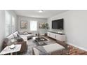 Bright living room featuring modern furnishings, stylish decor, and ample natural light from large windows at 6517 Paleface Pl, Charlotte, NC 28214