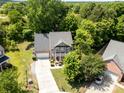 Aerial shot of a home nestled among lush greenery, featuring a long driveway and manicured lawn at 812 Thornapple Ct, Lake Wylie, SC 29710